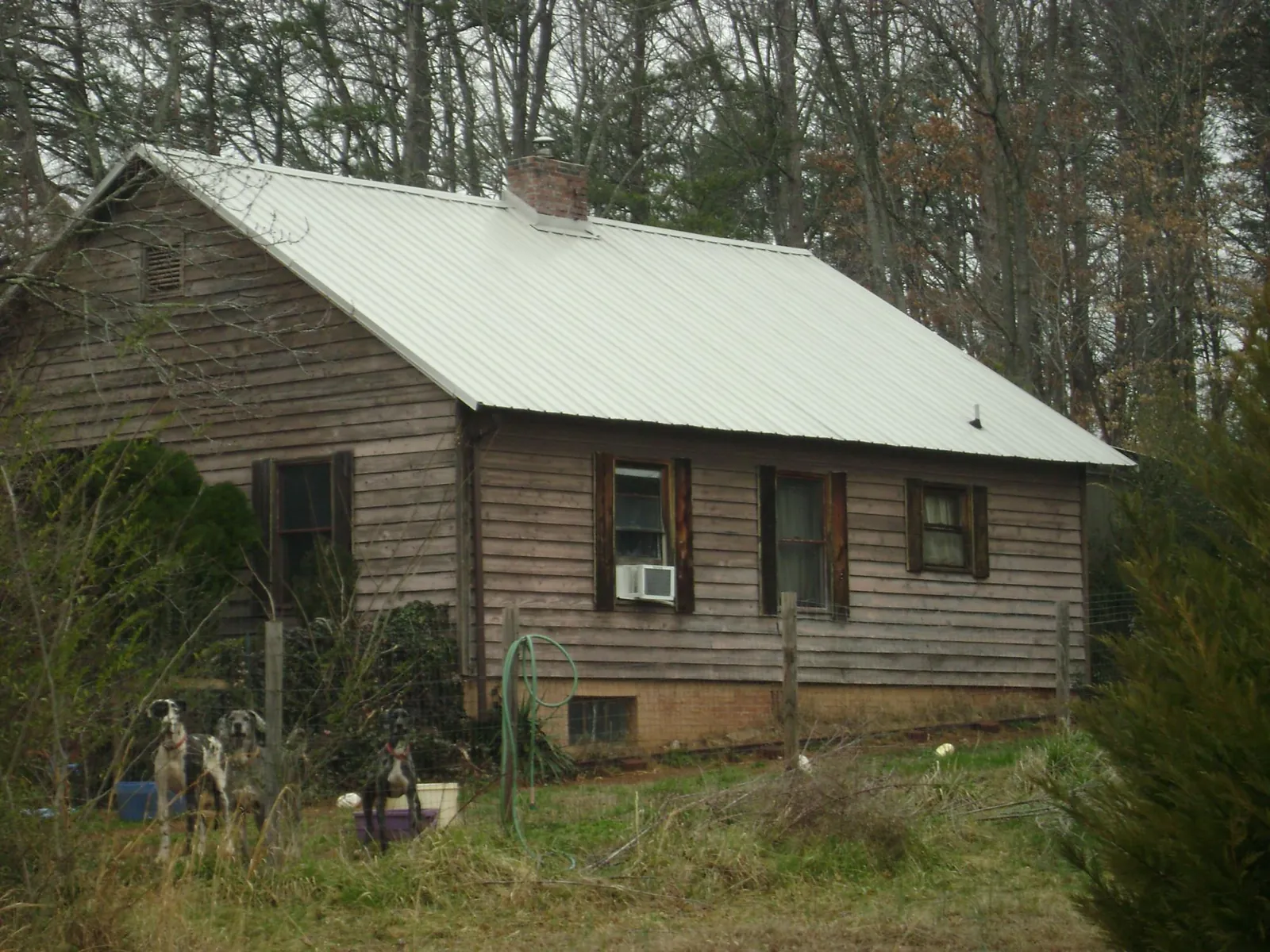 White metal roof on an old wood sided farmhouse, from a Metal Roof Installation job in Budd Lake